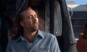 GIF of Nicolas Cage in Con Air showing off his glorious mullet.